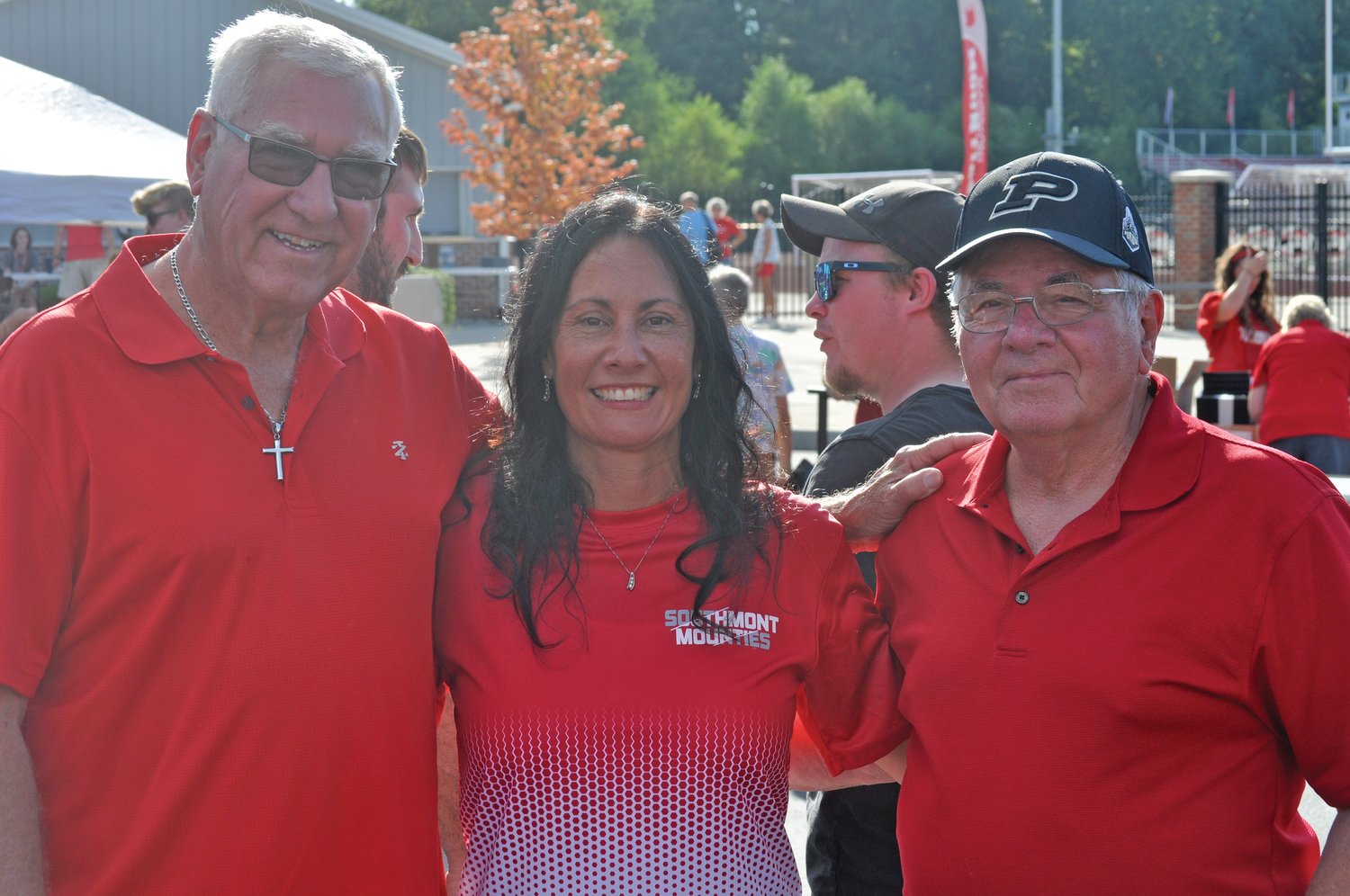 Retired Southmont High School teachers Ron Hess, left, and Rich Clouse with alumna Amanda Douglas at the school