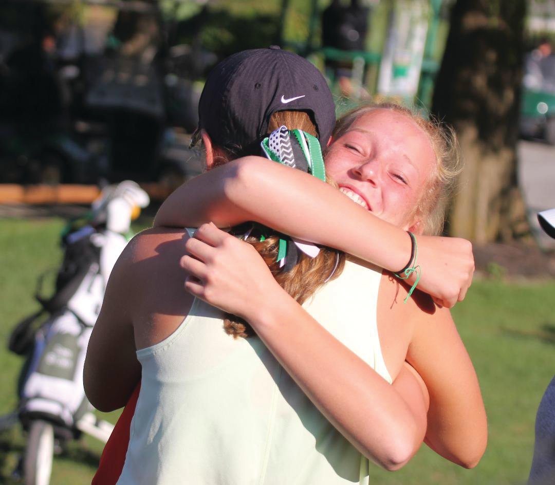 Southmont freshman Addison Meadows hugs Zionsville junior Addison Echeverria after the duo found out they both advanced to the girls state finals.