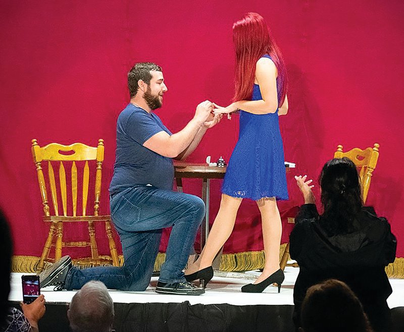 On Sunday at the Vanity Theater, Keith James and Amanda Taylor were completing their act about a couple moving from just meeting to thinking about forever. At that point Keith slipped off the chair and down on one knee and presented an engagement ring. Amanda was shocked, pleased and accepted to the wild cheering of audience and cast. The two were a part of "All in the Timing," a collection of four one-act plays made possible by the sponsorship of Tri-County Bank. A marriage date has not been set, but the play director, Keith Strain, suggested there was a play in 2023 called "Christmas Wedding."
