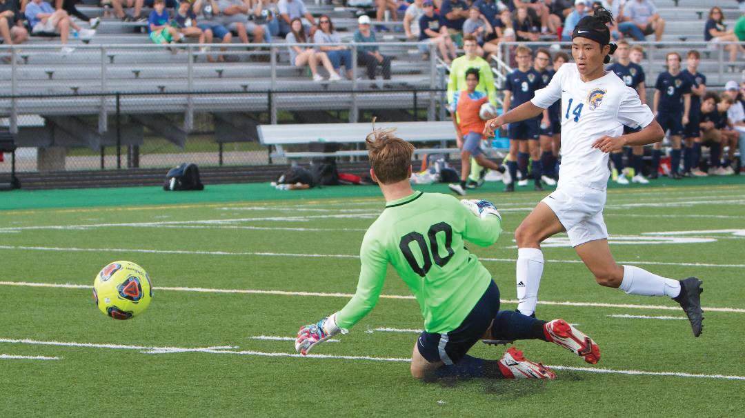 Crawfordsville freshman Ryotaro Nishina gets the ball past the Tri-West goalkeeper to give the Athenians a lead in the first half of the sectional final on Saturday.