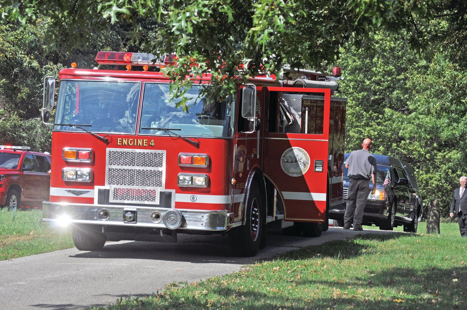 Crawfordsville Fire Department Engine 4 arrives at Oak Hill Cemetery North as part of the processional for longtime chief Dennis Weir on Monday.