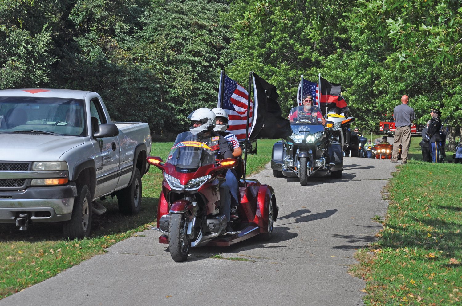The Indiana Patriot Guard arrives at Oak Hill Cemetery North as part of the funeral processional for longtime Crawfordsville Fire Chief Dennis Weir on Monday.