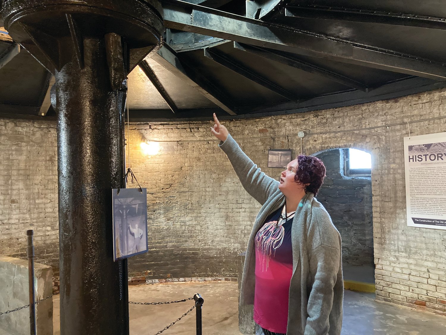 Elizabeth Peck, a docent at the Rotary Jail Museum, points to the mechanism in the jail