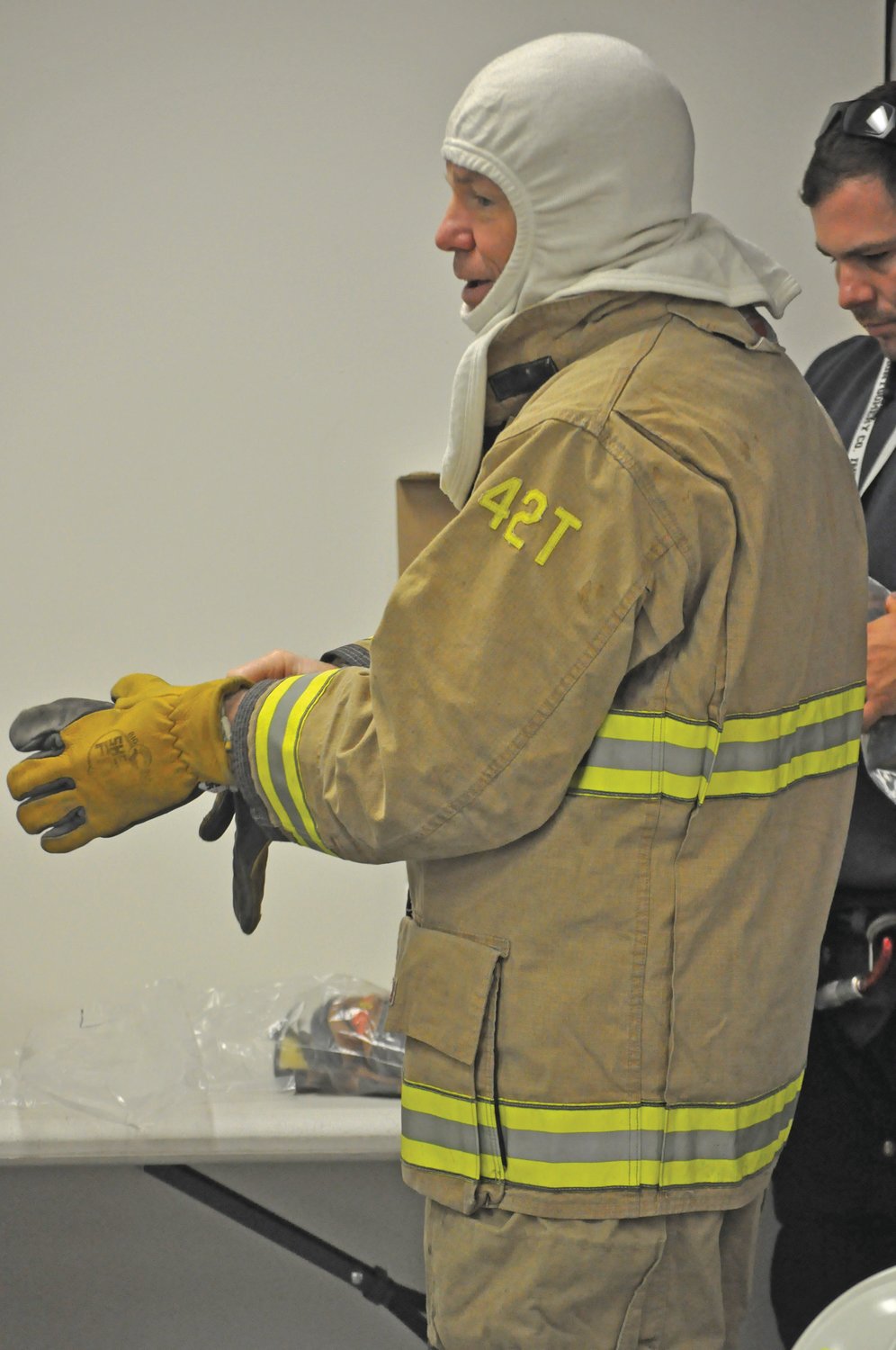 Crawfordsville City Councilman Ethan Hollander suits up for Fire Ops 101 on Saturday at the Public Safety Building on Elmore Street. The event sought to give elected and appointed officials a hands-on look at responding to fires and other emergencies.