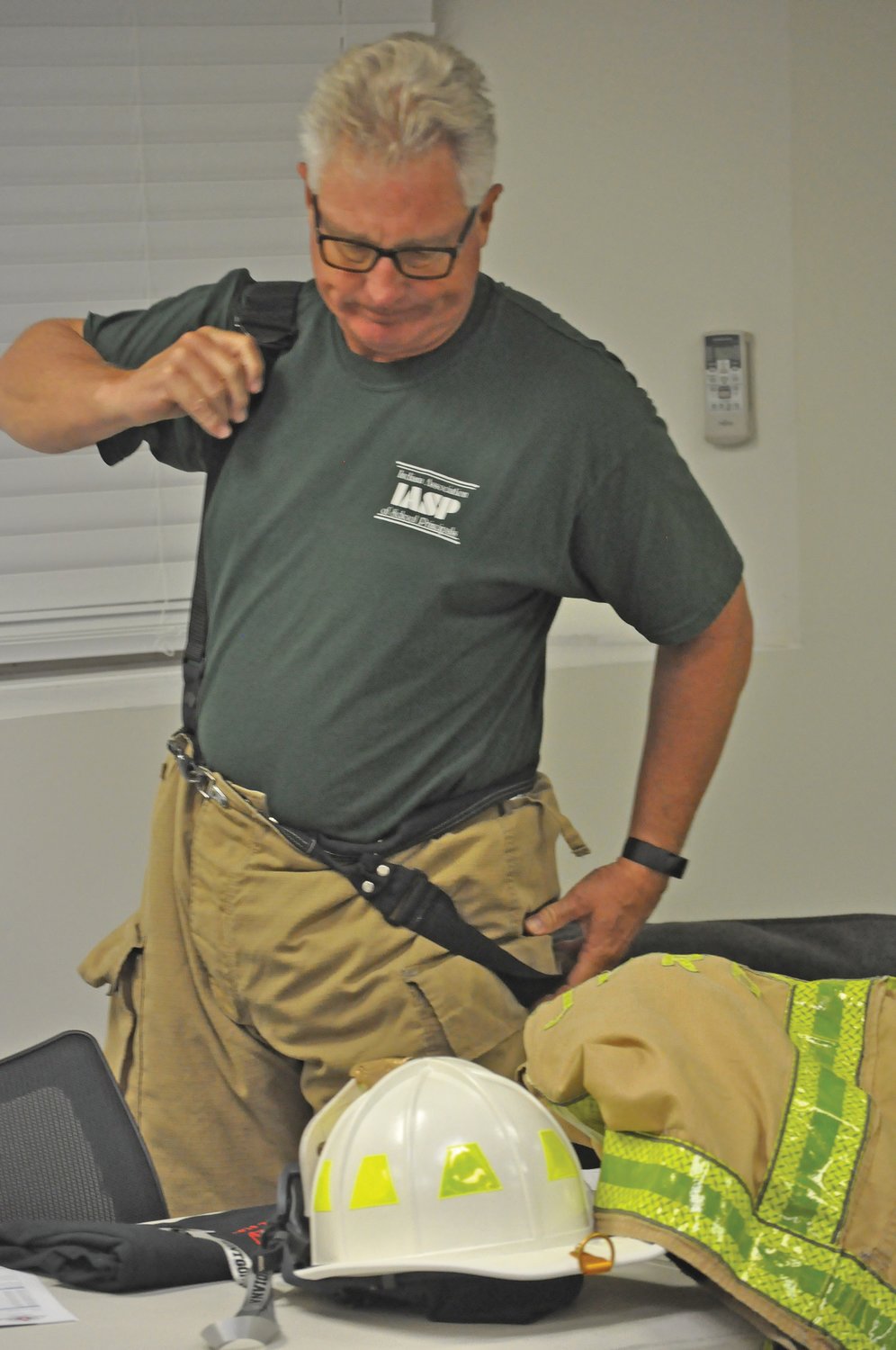 Montgomery County Council President Tom Mellish suits up for Fire Ops 101 at the Public Safety Building on Elmore Street on Saturday. The educational event for elected and appointed officials was organized by Crawfordsville Professional Firefighter