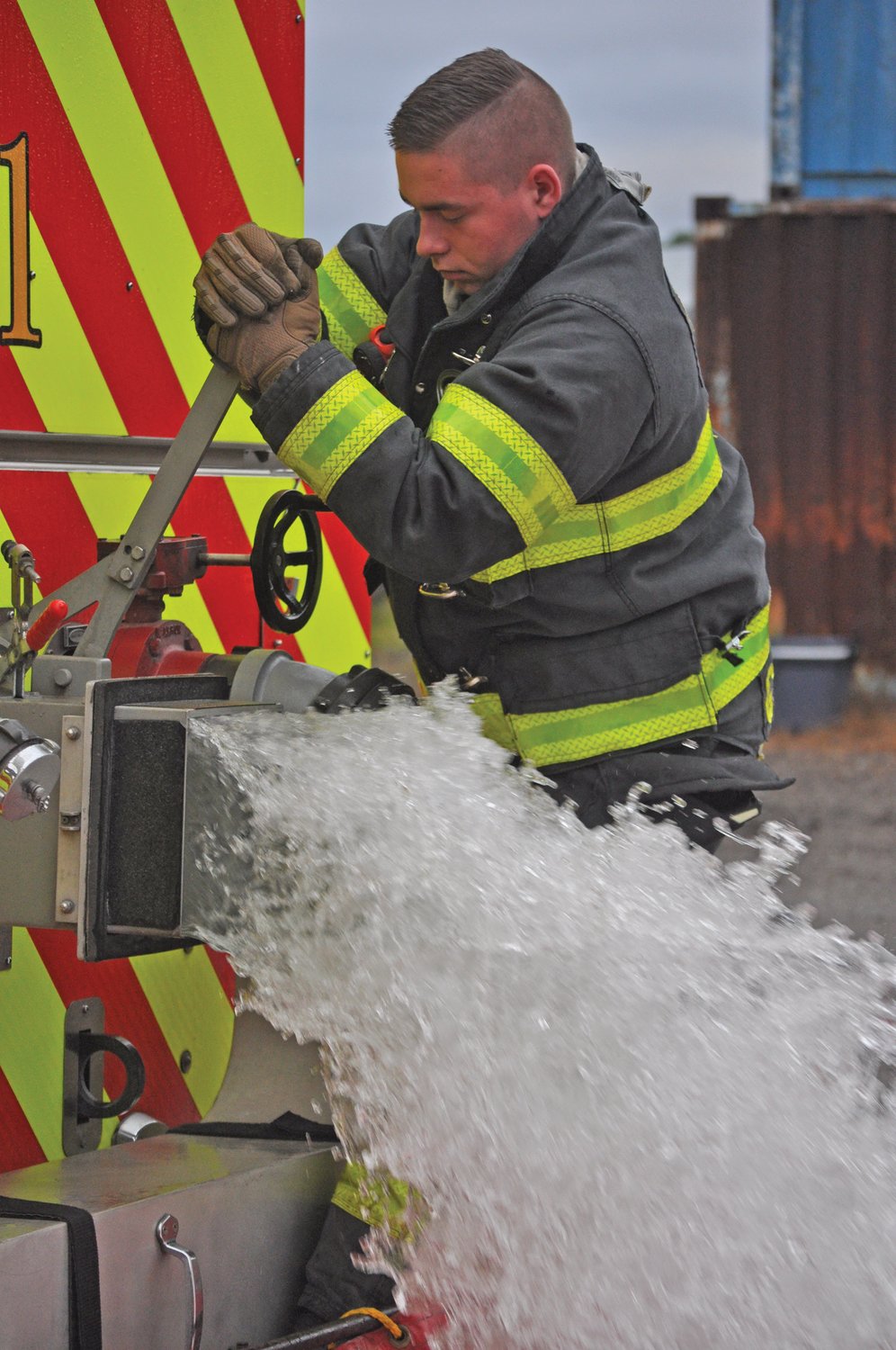 Crawfordsville firefighter Gavin Waddell pumps water for the Fire Ops 101 event at the department