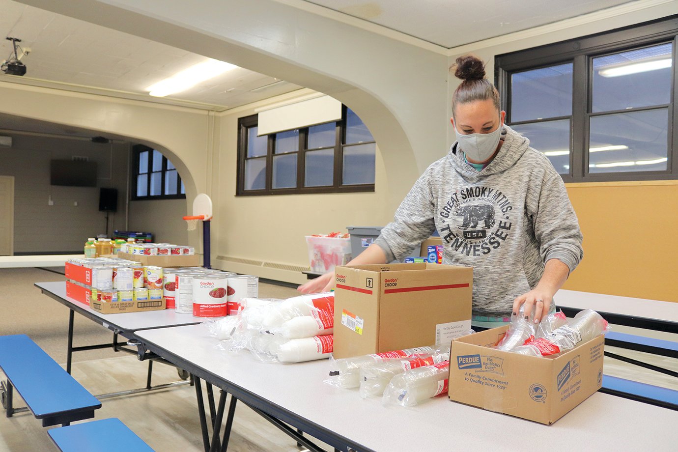 Andrea Posthauer works to organize paper and plastic products ahead of last year’s Community Thanksgiving Dinner at First United Methodist Church. Dine-in service resumes this year.