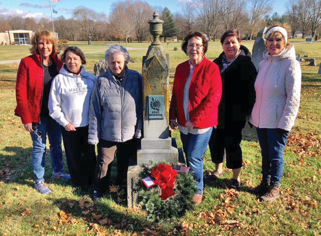 Members of the Dorothy Q Chapter, NSDAR, place a wreath of remembrance on the grave of Lucinda Hardee McMullen, a Real Daughter.