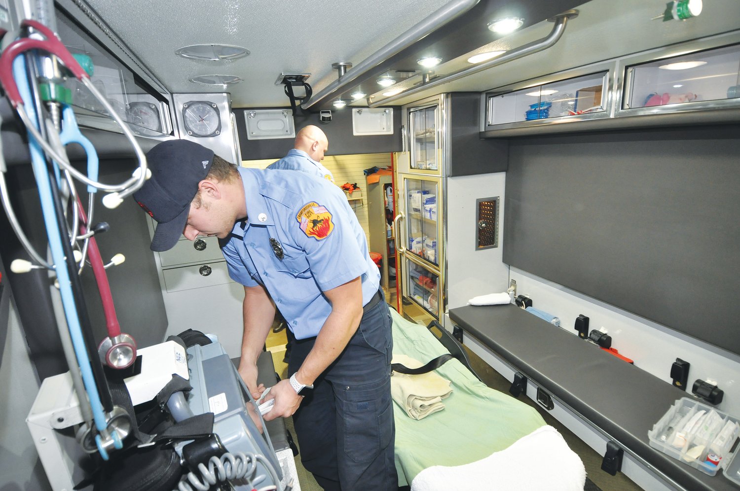 In this 2018 photo, Logan Meadows, an EMT with the Crawfordsville Fire/EMS Department, and Trent Stetler, a paramedic, go through inventory and restock one of the city's ambulances the department staffs each day.