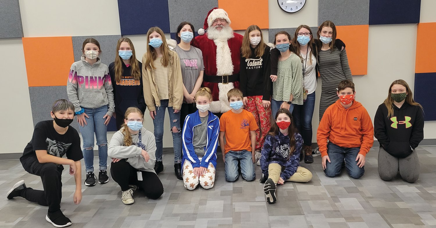 North Montgomery Middle School students involved in the Project Evergreen and Santa pose for a photo Friday.