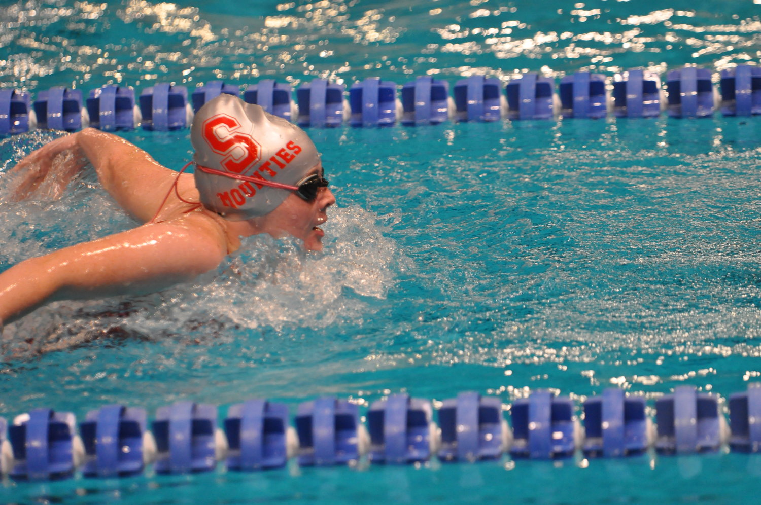 Alexis White swims in the 100 butterfly for the Lady Mounties.