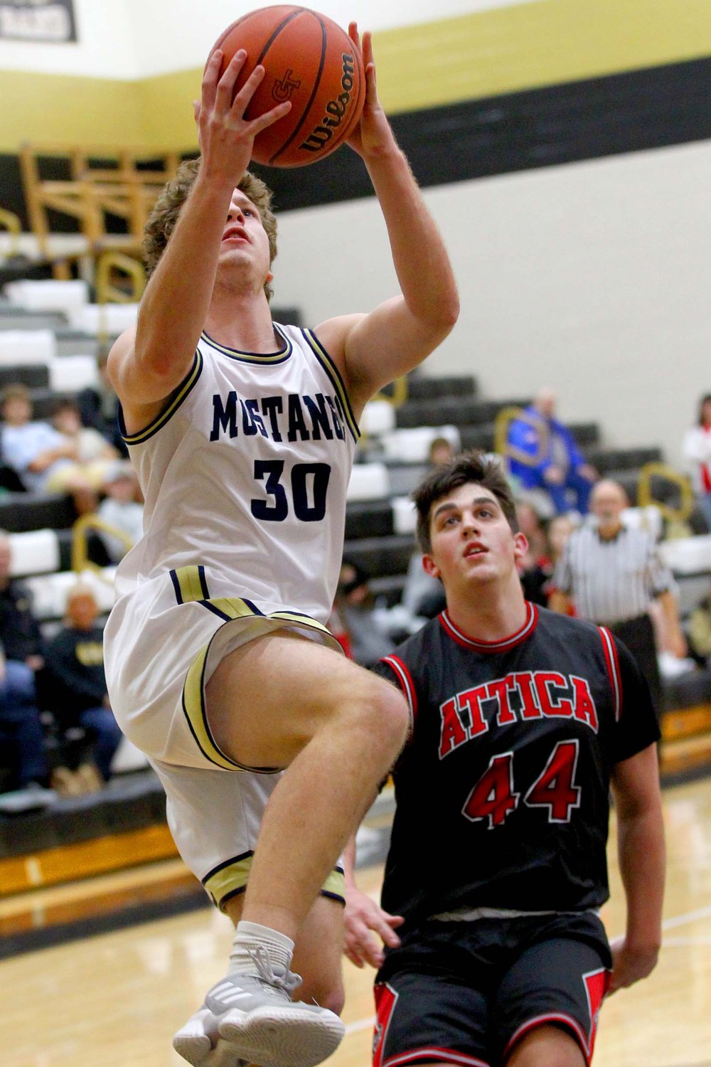 Owen Acton of Fountain Central goes up for a lay-up after getting past Seth Miller of Attica.