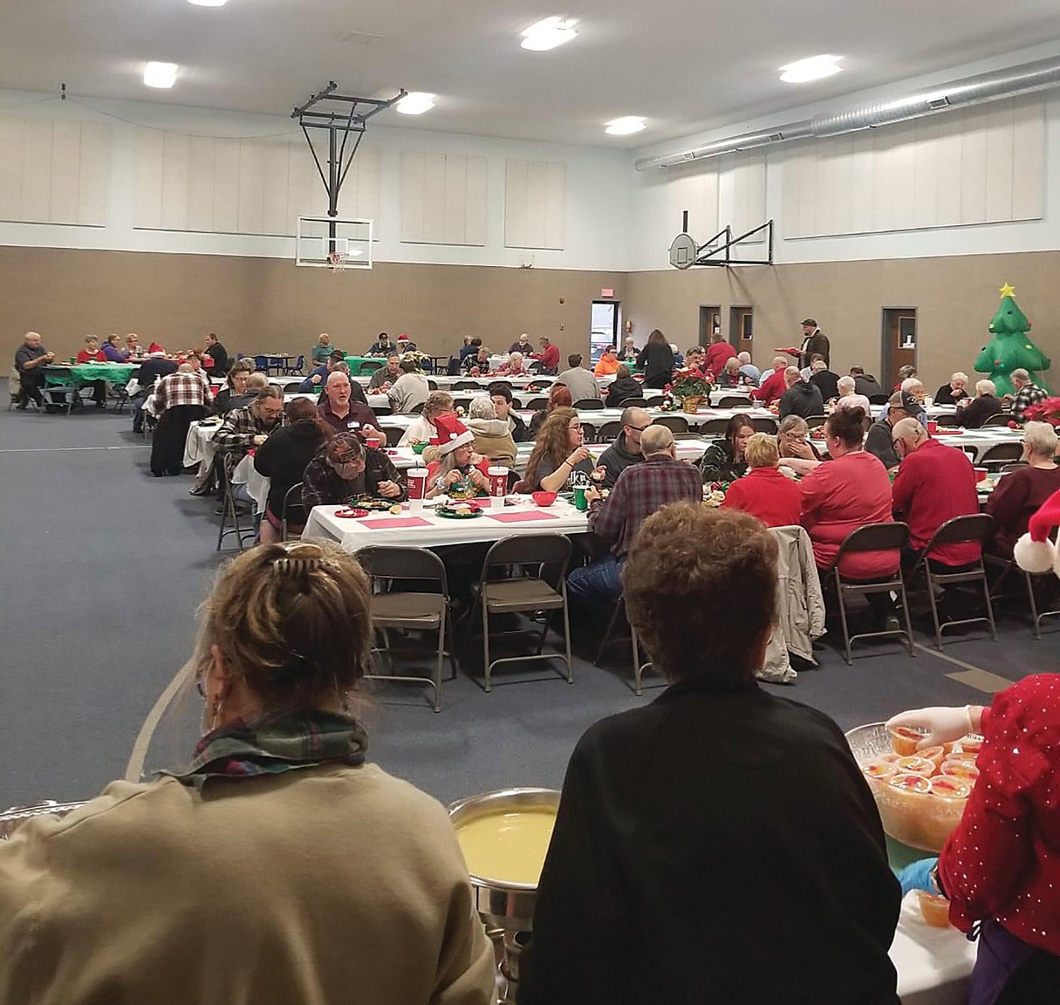 Montgomery County Christmas Dinner volunteers watch as diners enjoy a Christmas Day meal.