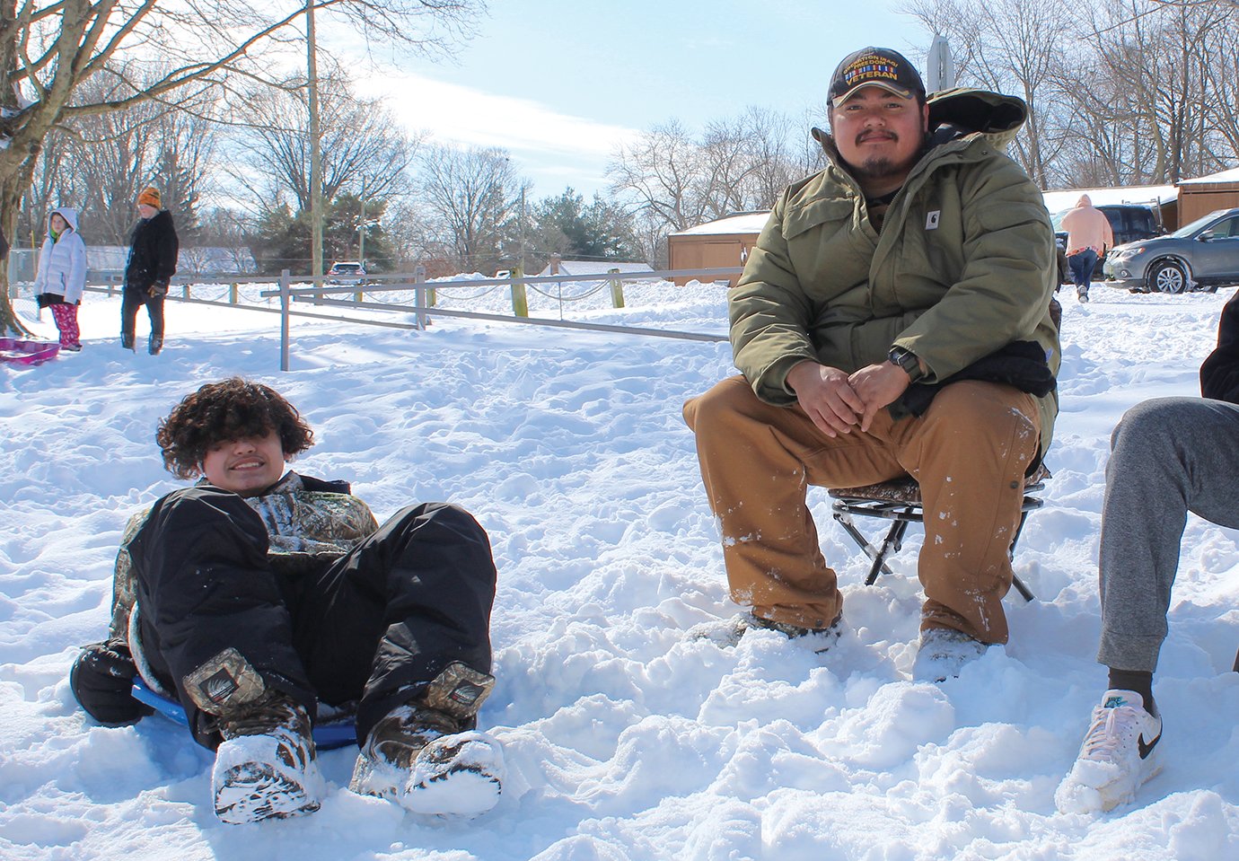 Jessea Tovez, left, and T.J. Tovez are hardly bothered by the snow and bitter cold Friday at Milligan Park.