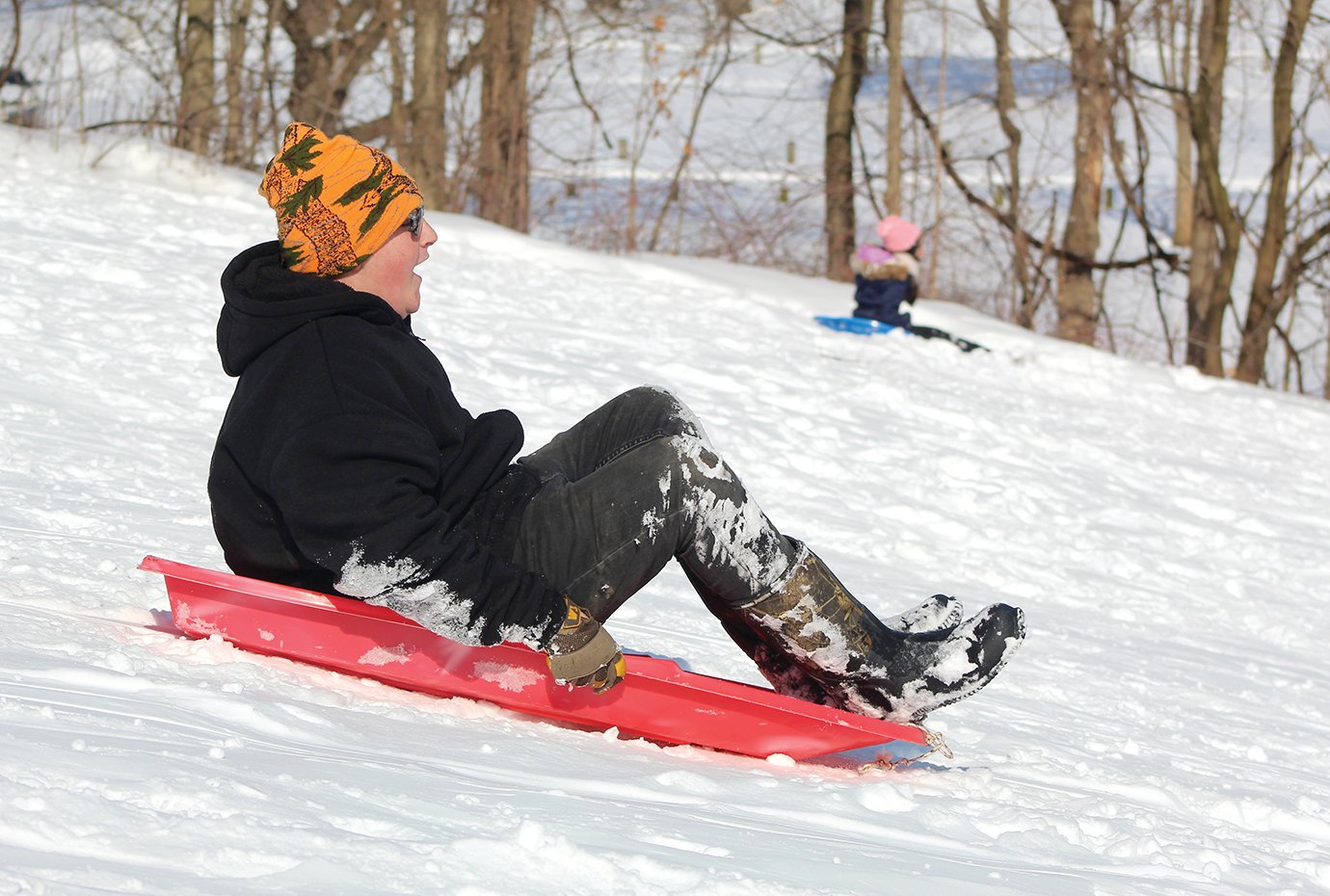Joseph Melton, 15, sleds the slick slopes of Milligan Park on Friday.