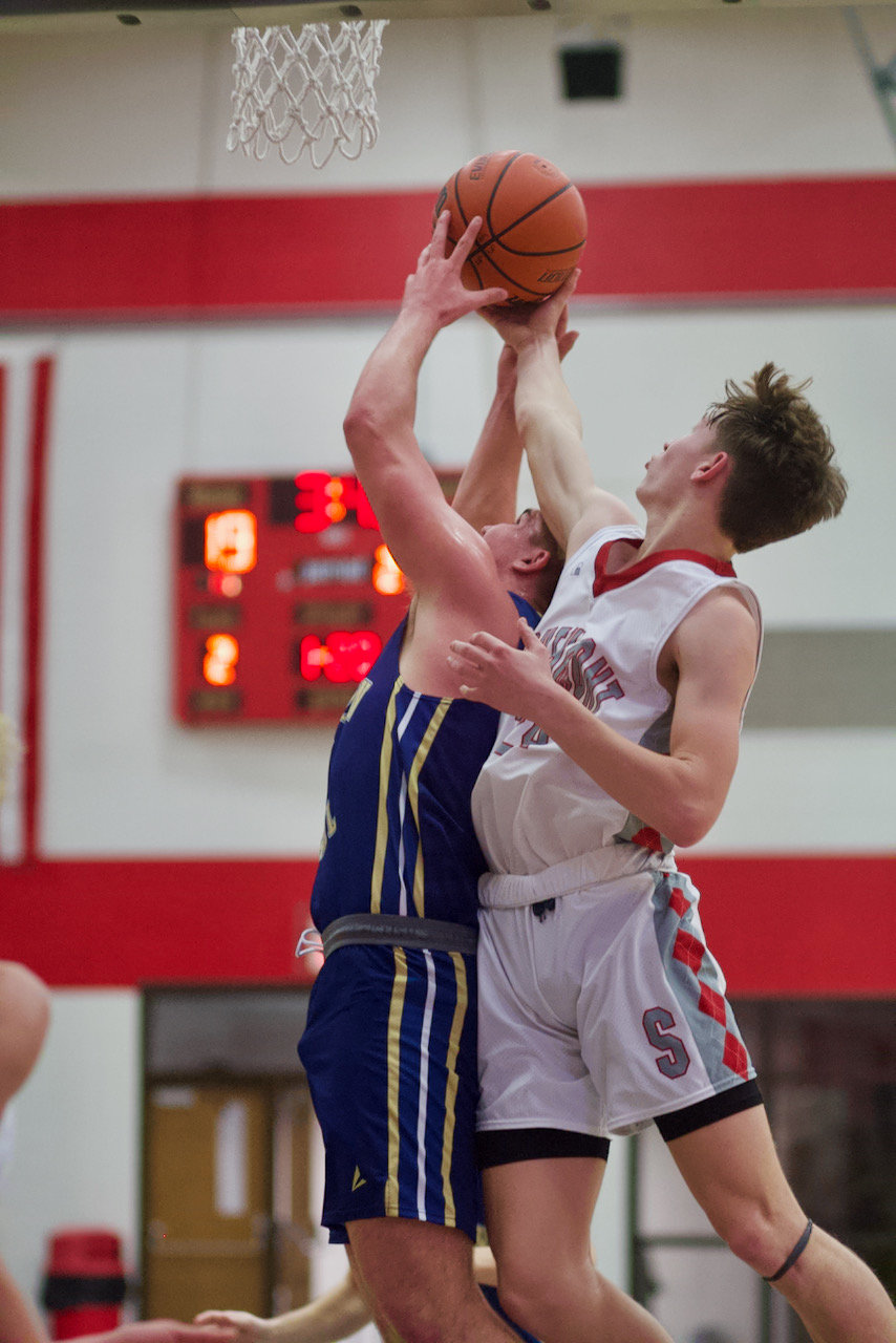 Brewer goes up for a block against Fountain Central.