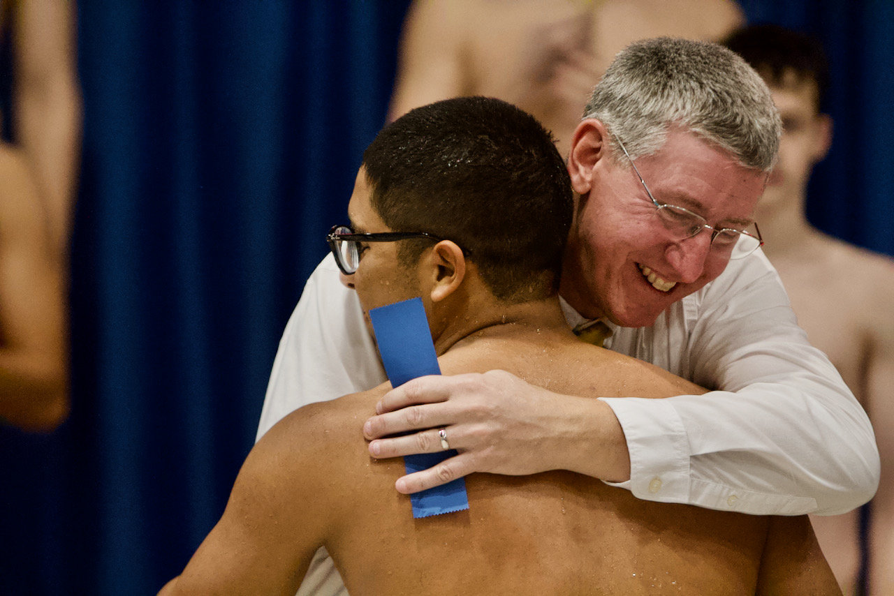 Crawfordsville coach Kevin Hedrick and Thristan Callejas celebrate Callejas's victory in the 100 butterfly.