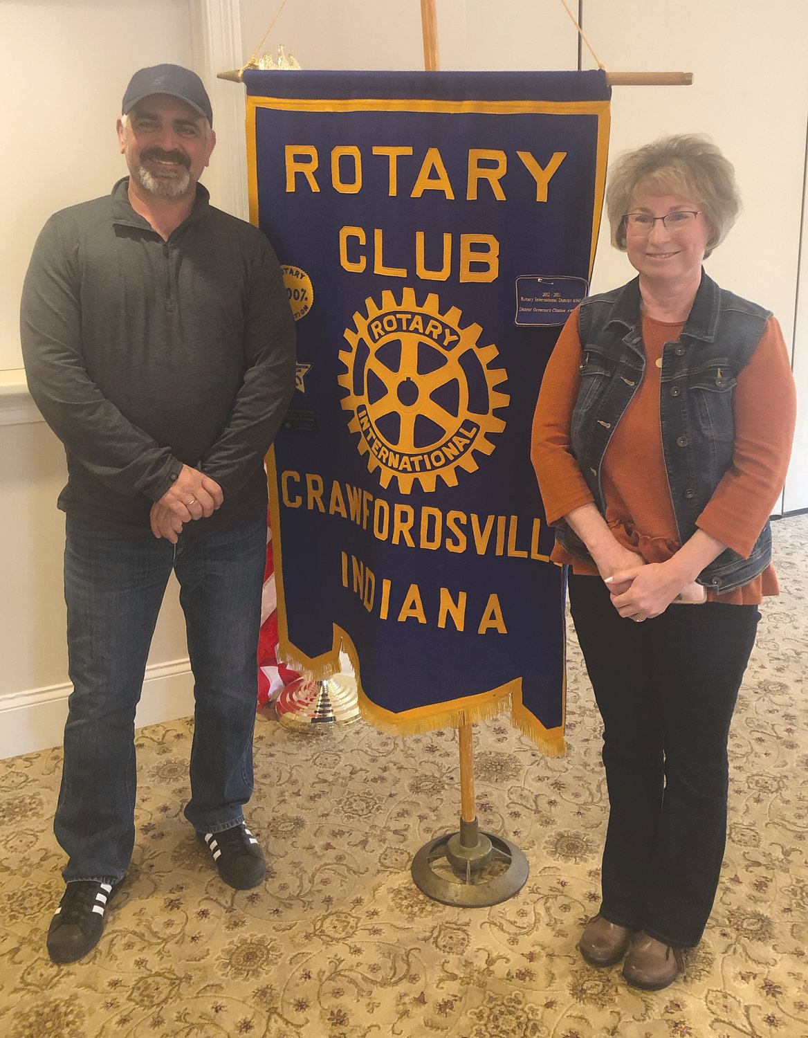 Rotary president Roger Azar, left, poses with guest speaker Sue Zachary of Pam's Promise.
