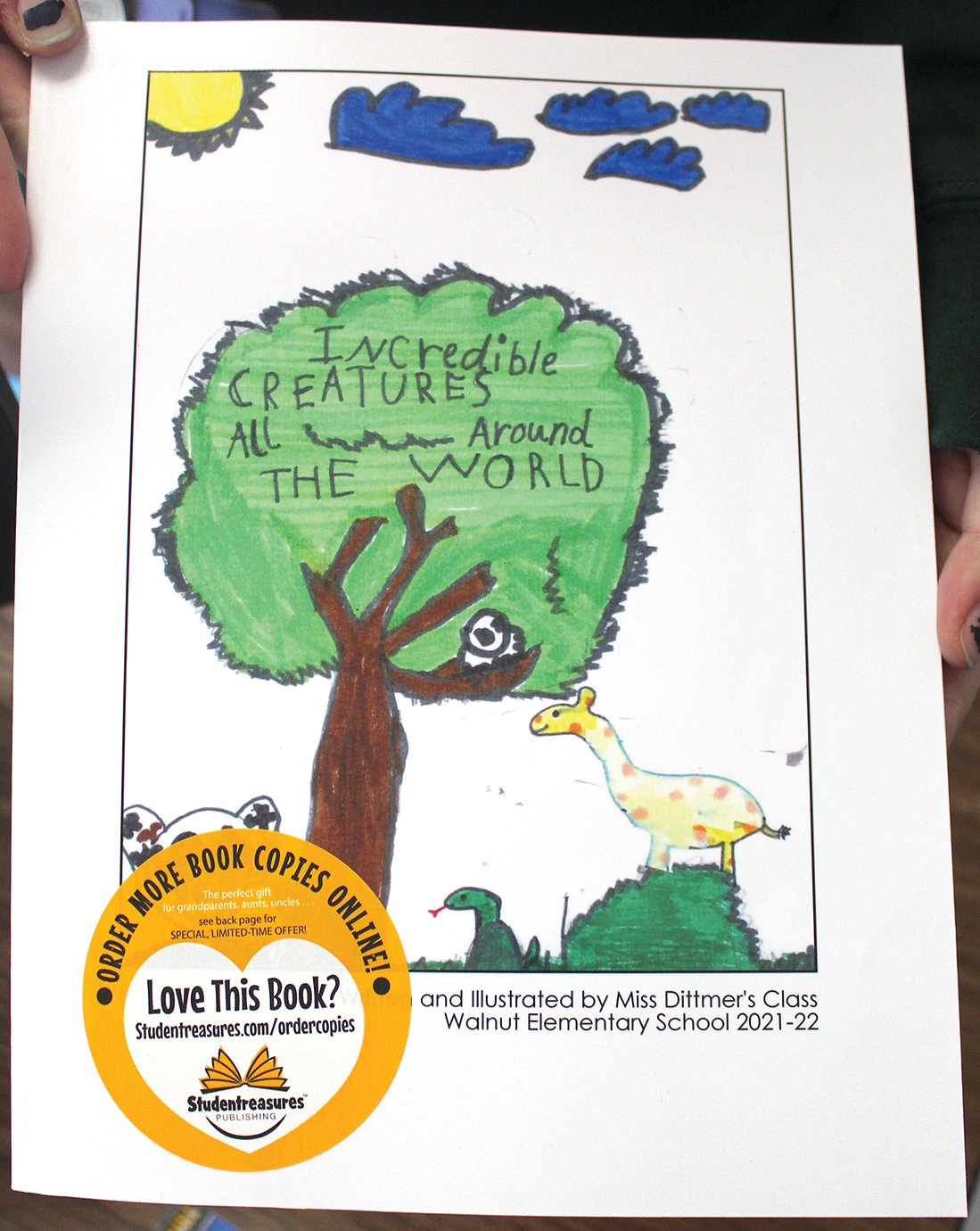 The cover of the book, which features the title “Incredible Creatures All Around the World, includes hand-drawn sketches by the students and informational paragraphs from each in their own handwriting.