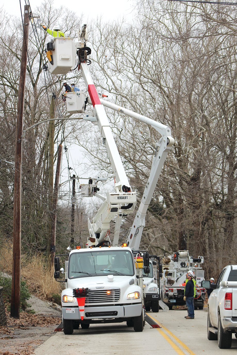 A total of four bucket trucks were required to lift crews 30-plus-feet in the air to restore power to the west end of Crawfordsville.