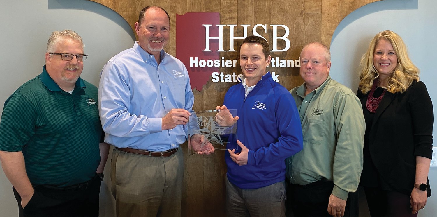 Displaying HHSB’s Five Star Member award from the Indiana Bankers Association are, from left, Trent Smaltz, CLO; Brad Monts, president/CEO; Zach Hockersmith, CFO; Trey Etcheson, chairman of the board; and Amber Van Til, IBA president and CEO.