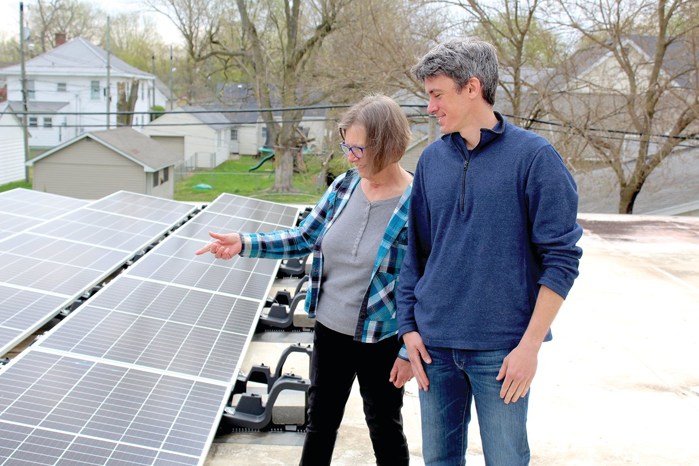 League of Women Voters Climate Team members Helen Hudson and John Smillie run a check on the newly installed solar panel system on the roof of the Youth Service Bureau.
