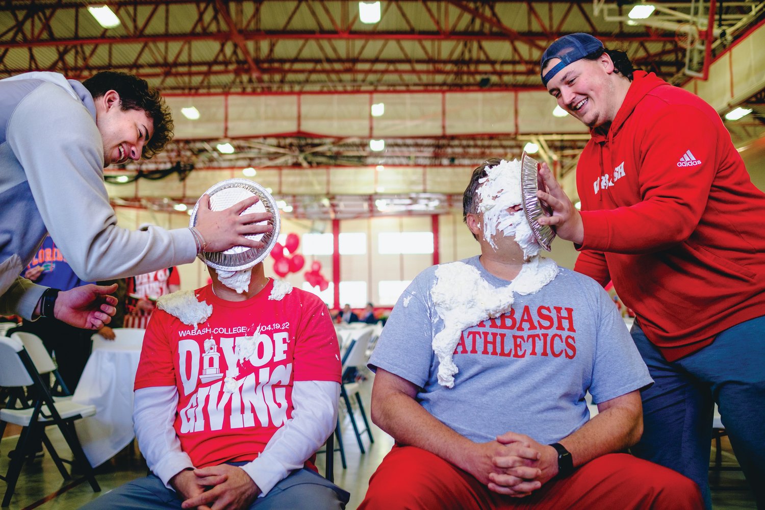 Head Basketball Coach Kyle Brumett, left, and Assistant Football Coach Olmy Olmstead ’04 won the raffle to get a pie in the face from students to celebrate the Day of Giving at an all-campus lunch April 19.