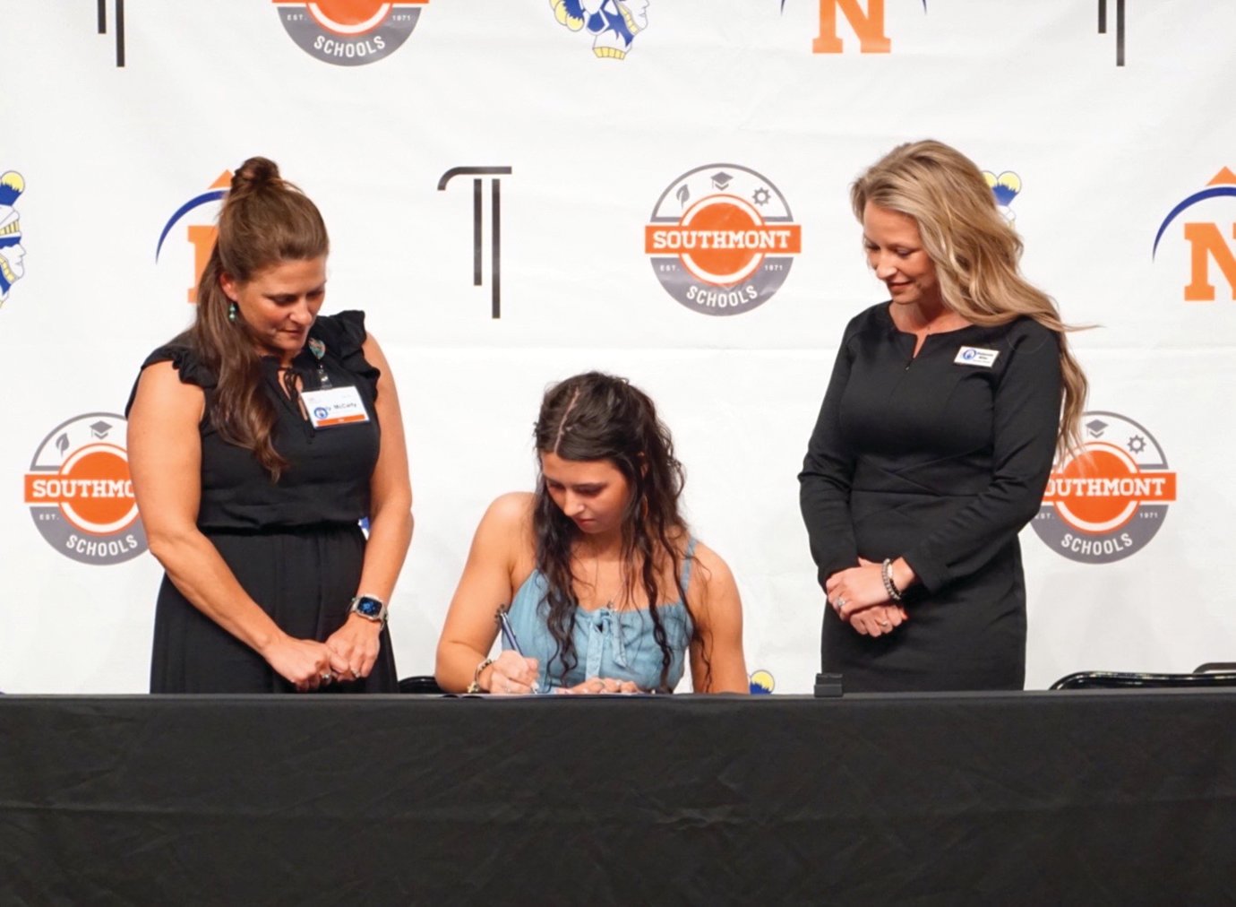 Athenian Liddy McCarty signs a letter of intent to join the staff of Ben Hur Health and Rehabilitation at North Montgomery Tuesday alongside facility representatives Misty McCarty, left, and Mackenzie Miles.
