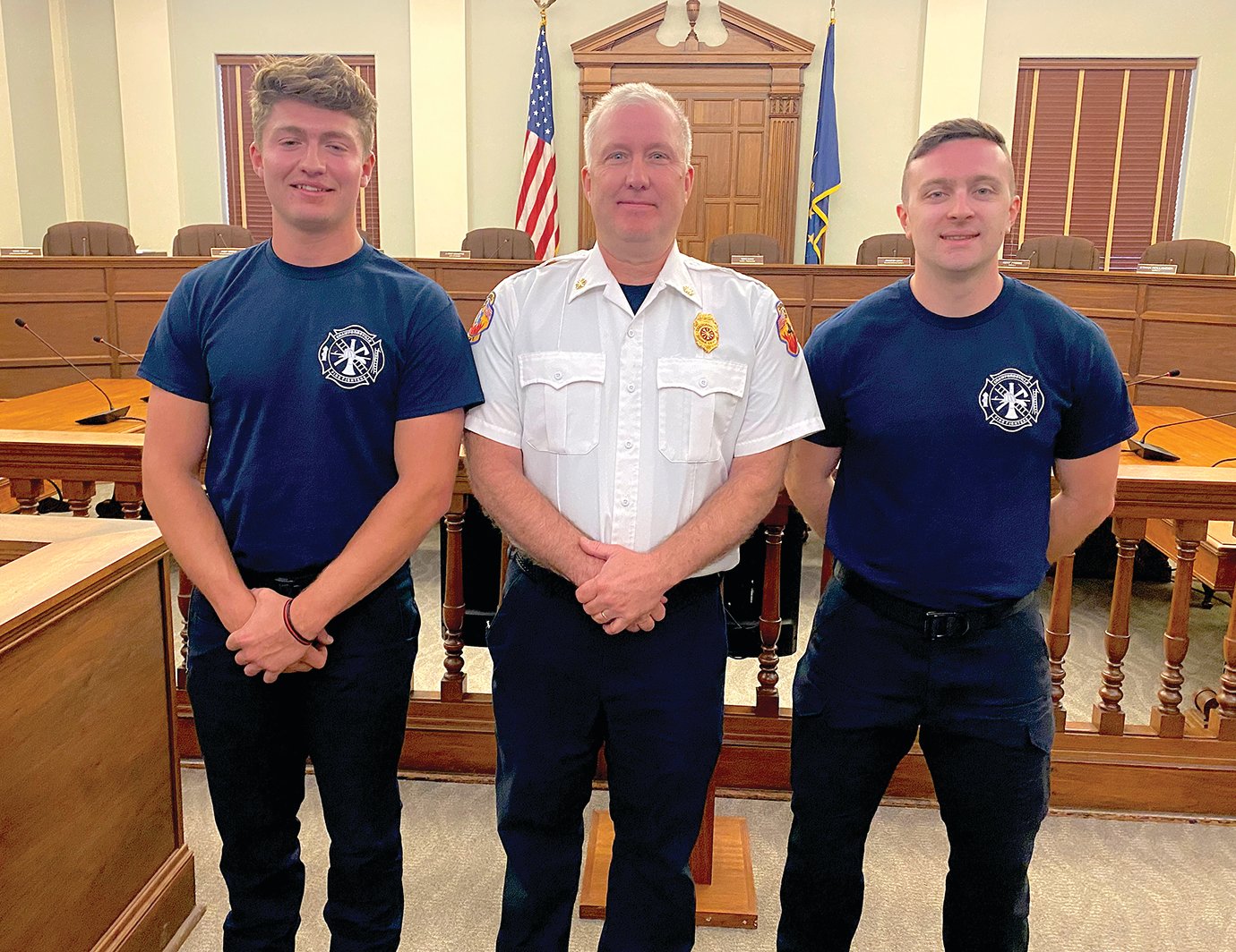 Crawfordsville Fire Department Chief Scott Busenbark, center, welcomes the city’s newest firefighters to the department Wednesday following the traditional swearing in of officers. Grant Kennedy, left, and Chris Thibaut, at City Hall.