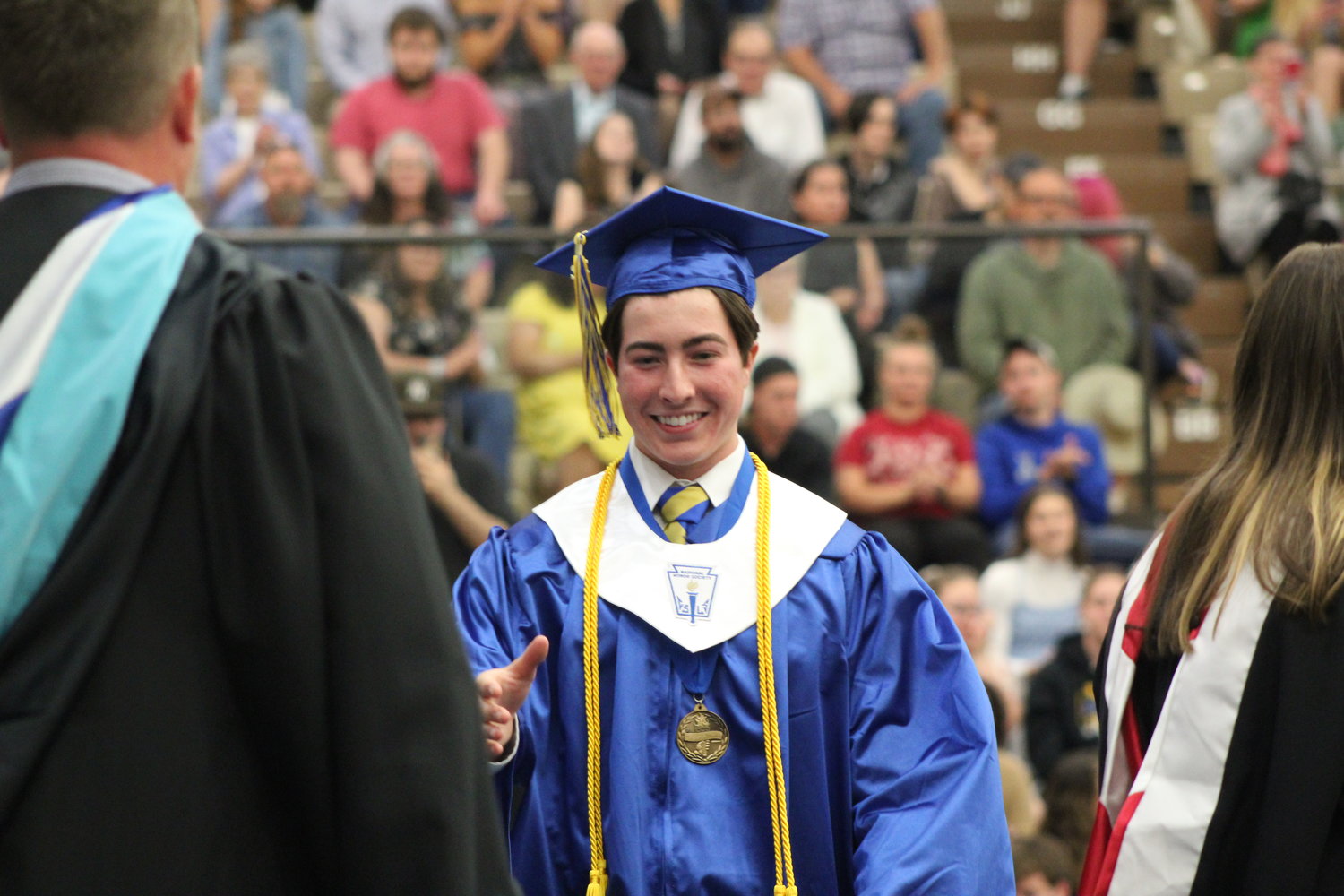 Valedictorian Marshall Horton walks across the stage to receive his diploma.