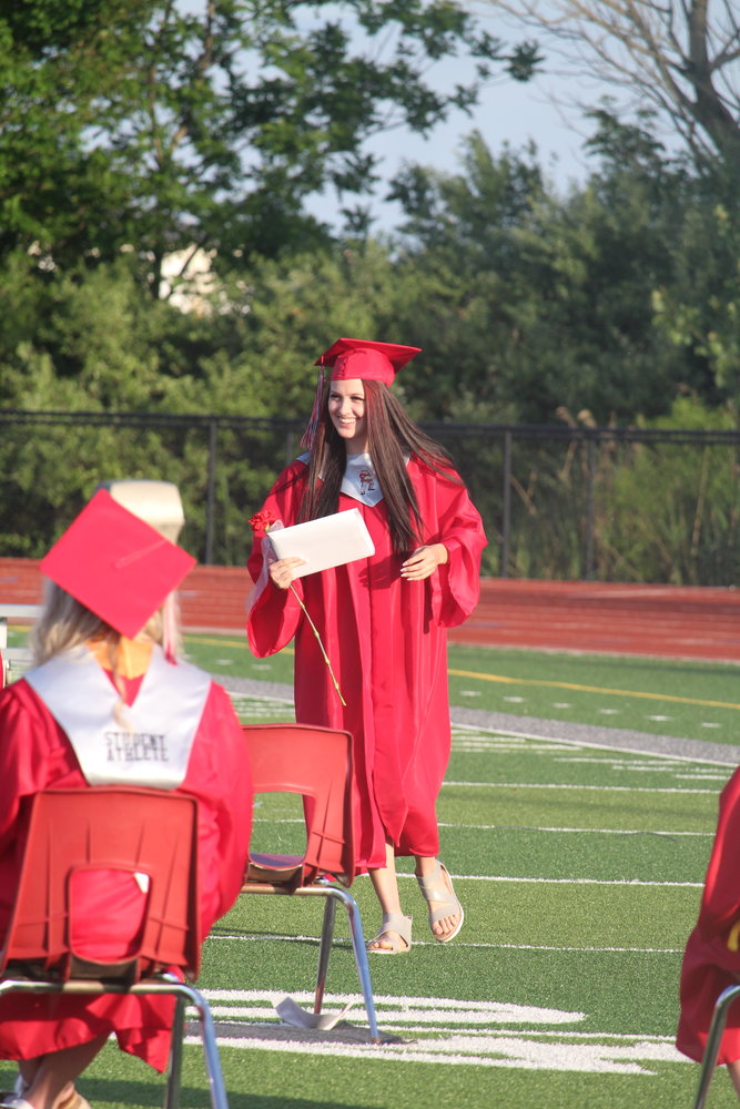 Jade Gann is all smiles as she walks back to her seat after receiving her diploma.