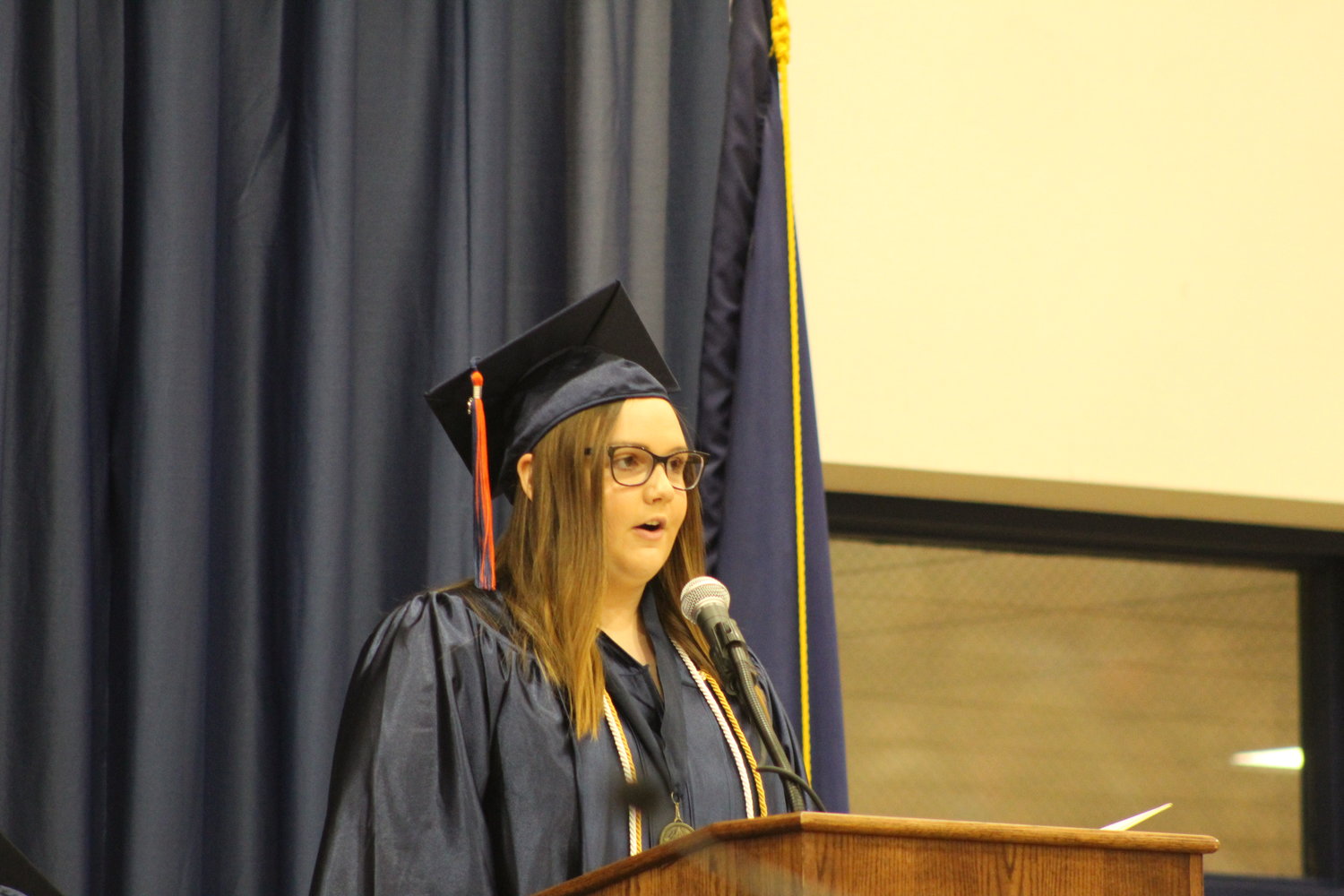 Class vice president Ella Stultz gives the opening remarks Saturday to the graduating class of 2022.