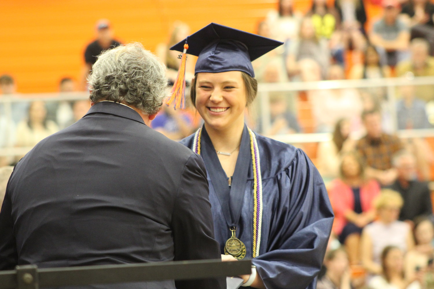 Katie Rice walks across the stage and receives her diploma.