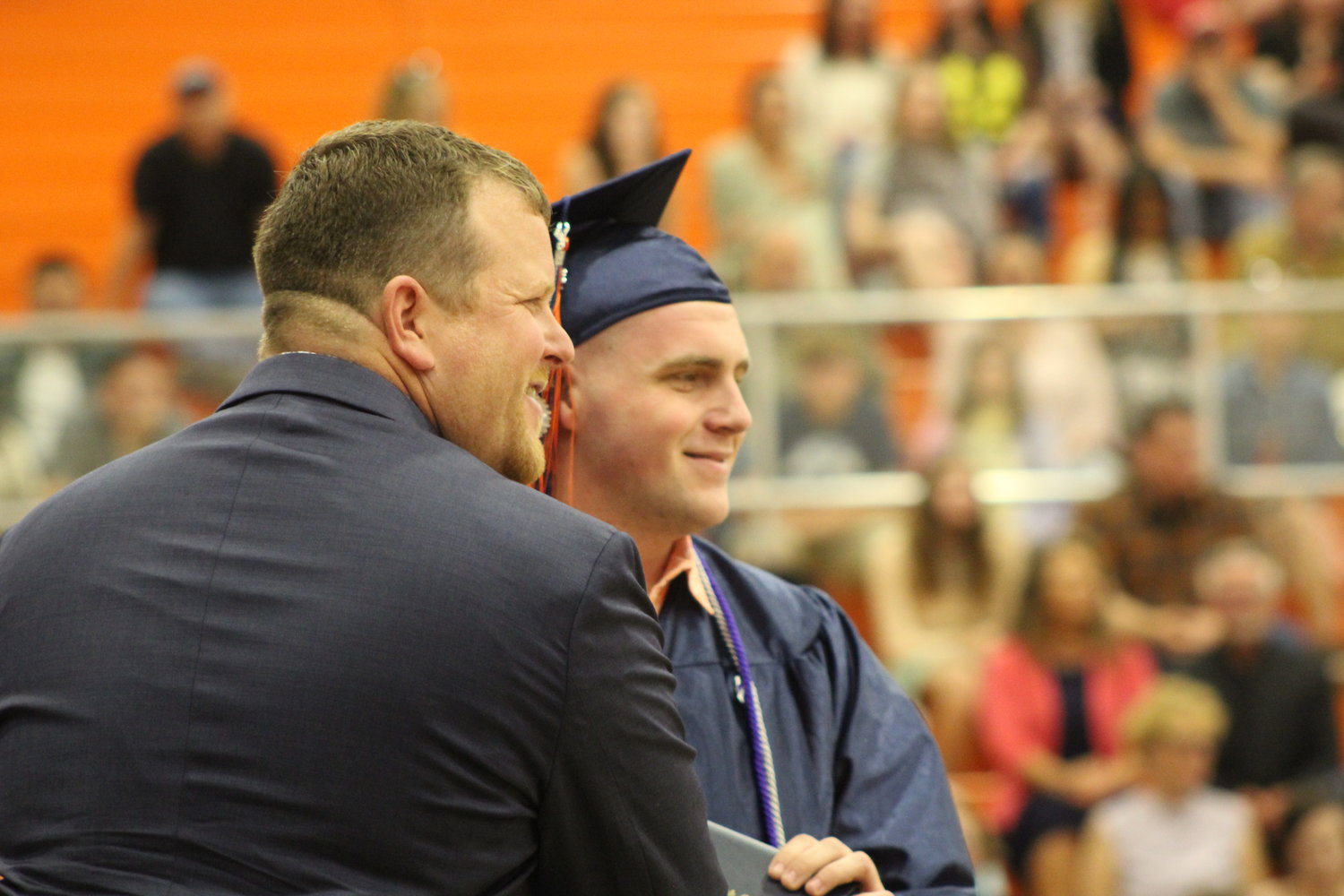 Owen Query stops for a photo after receiving his diploma.