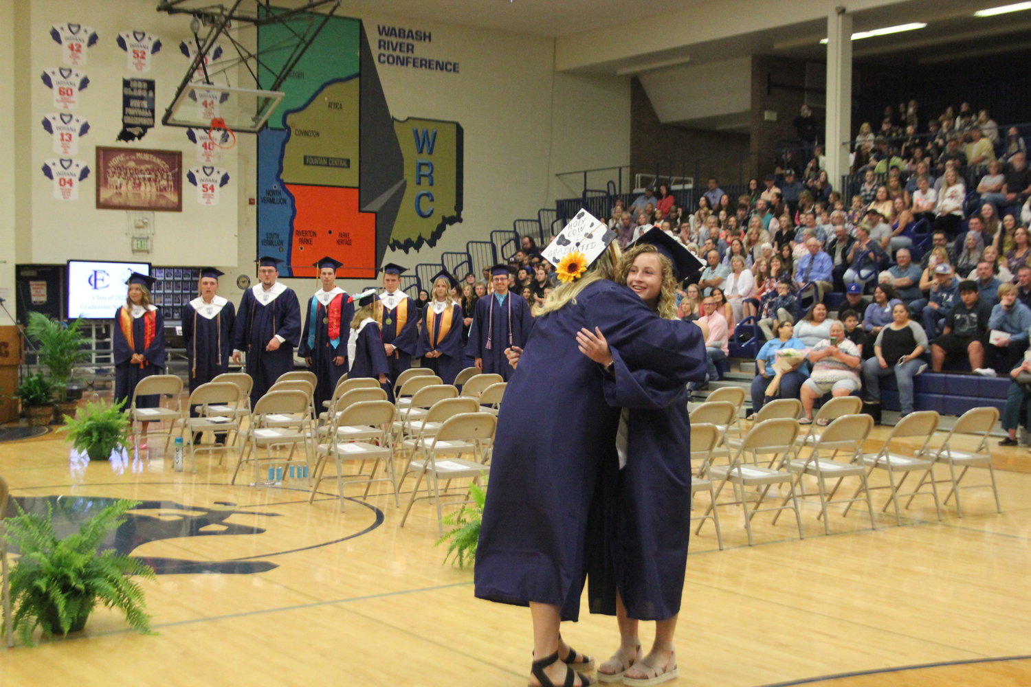 Cheyanne Thompson and Courtney Sims embrace before taking their seats.