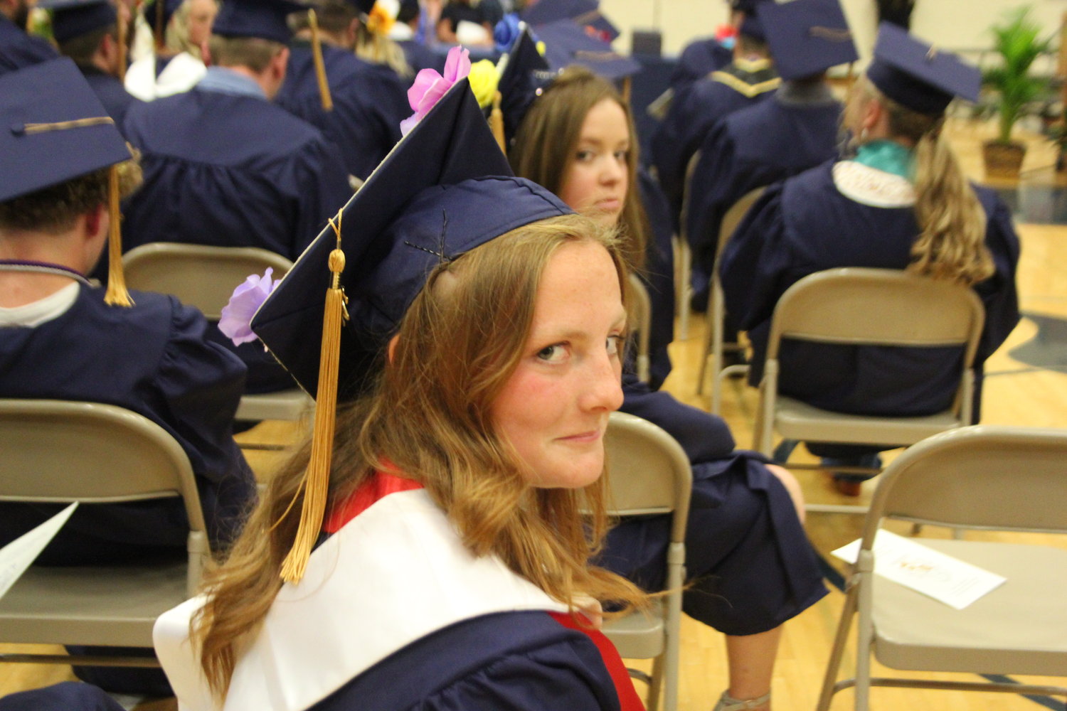 Haley Webb and Chaney Patton wait for their diplomas.