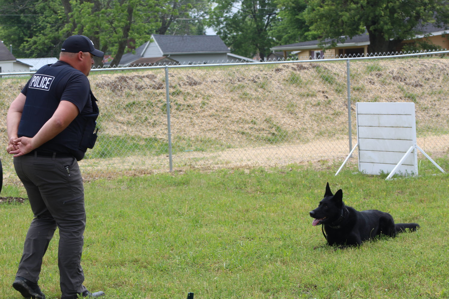Officer Adam Stapleton walks his dog Nevil through an obedience course.