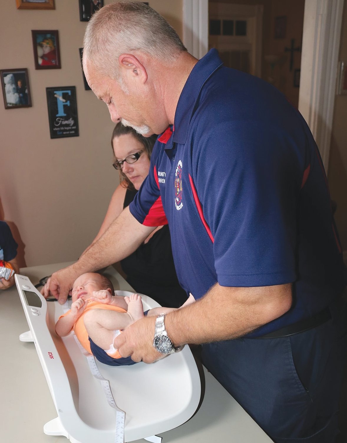 Project Swaddle Paramedic Darren Forman conducts a routine in-home visit with a local mother and baby during the 16 weeks after birth. Forman checks for overall baby and mother health and refers participants to the proper services when needed.