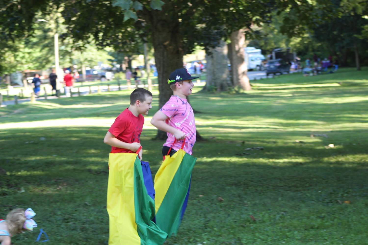 Kids enjoy sack races in the park.