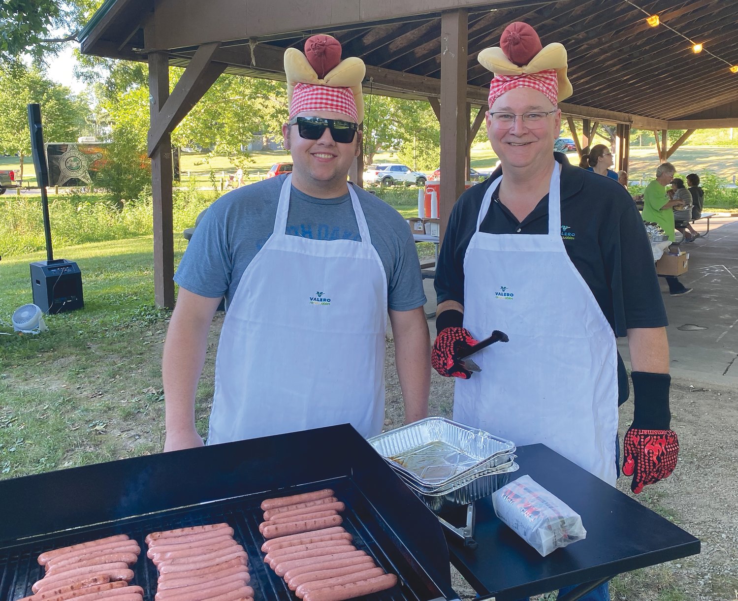 Jake Peterson and Mark Brown from Valero Renewables grill hot dogs for the crowd.