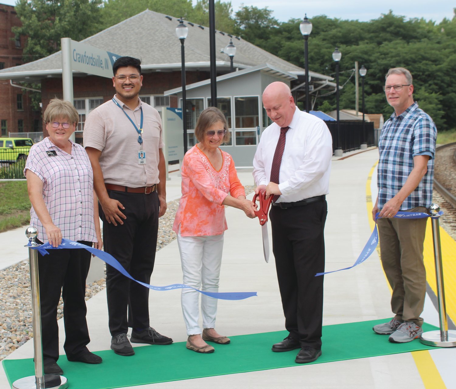 Crawfordsville Mayor Todd Barton and Dr. Helen Hudson cut the ribbon at the newly renovated Amtrak train station in Crawfordsville. They were joined by, from left, Sue Lucas of Crawfordsville Main Street, an Amtrak official and City Councilman Jeff Lucas.