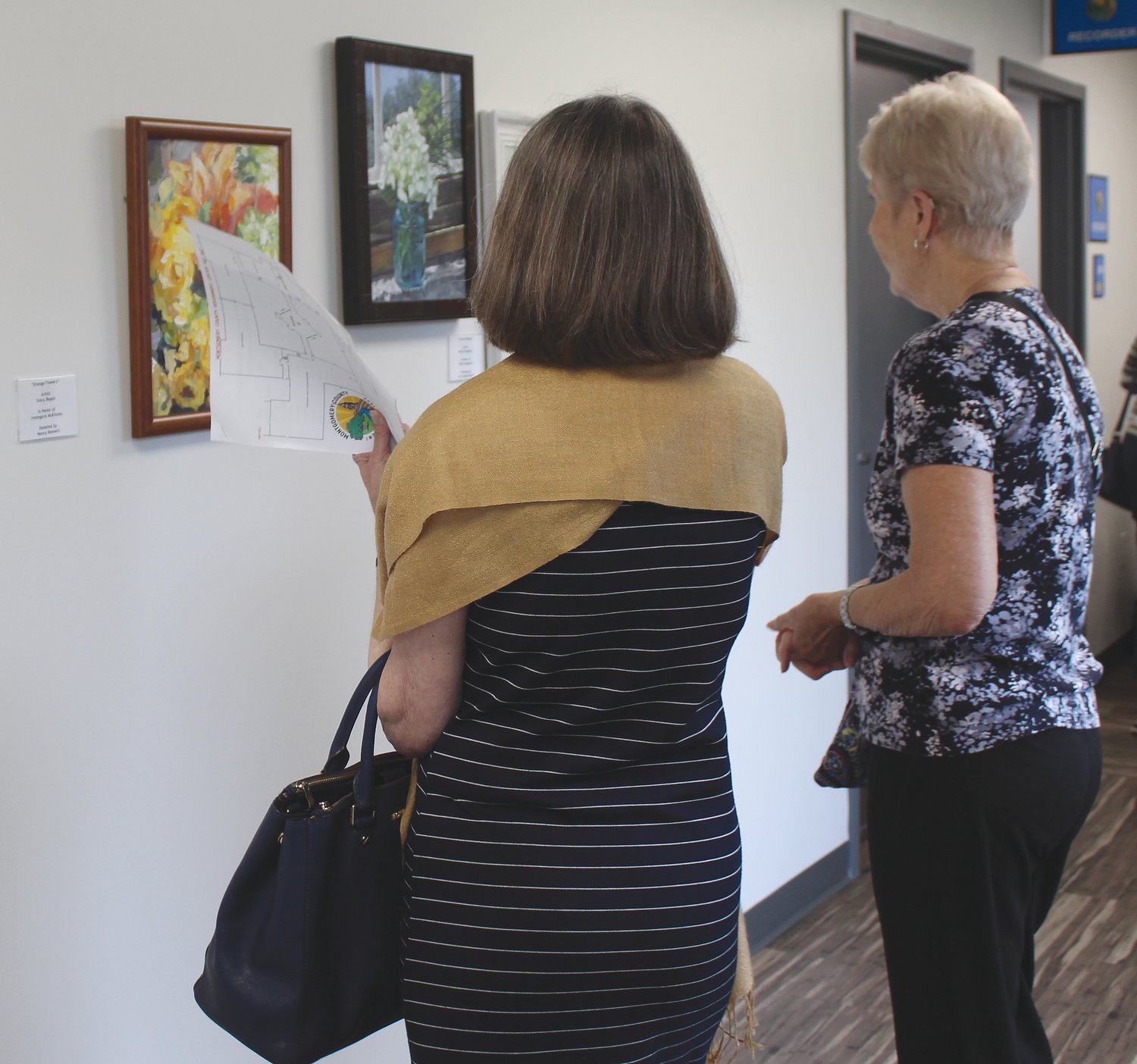 Visitors view the many pieces of artwork donated by local artists.