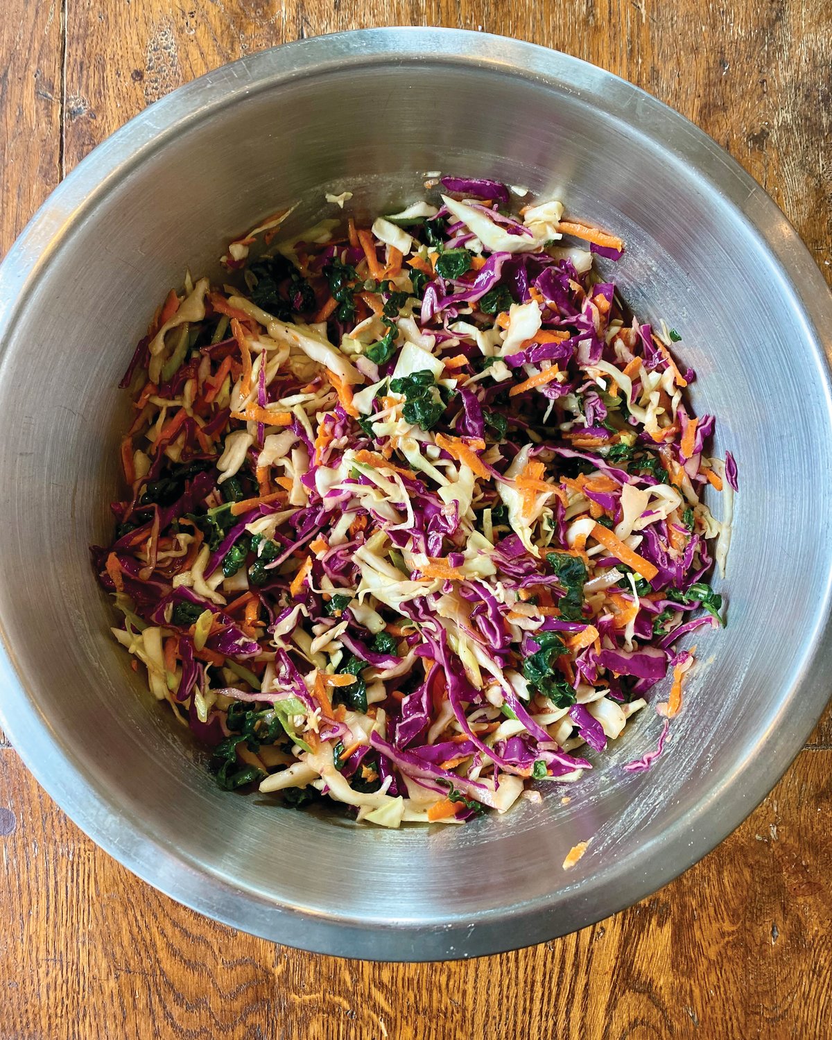 The key ingredient in this slaw is grated onion with its juices. It manages to bind this simple slaw together and provide the elusive je ne sais quoi that compels you to take another (and another) bite.