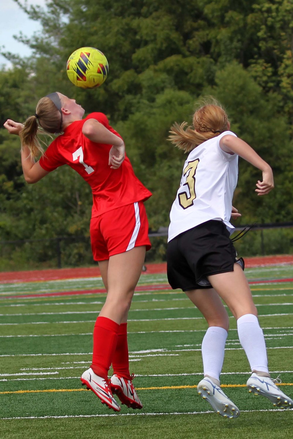 Emma Phillips of Southmont goes up over Emma Holycross of Covington for a header.