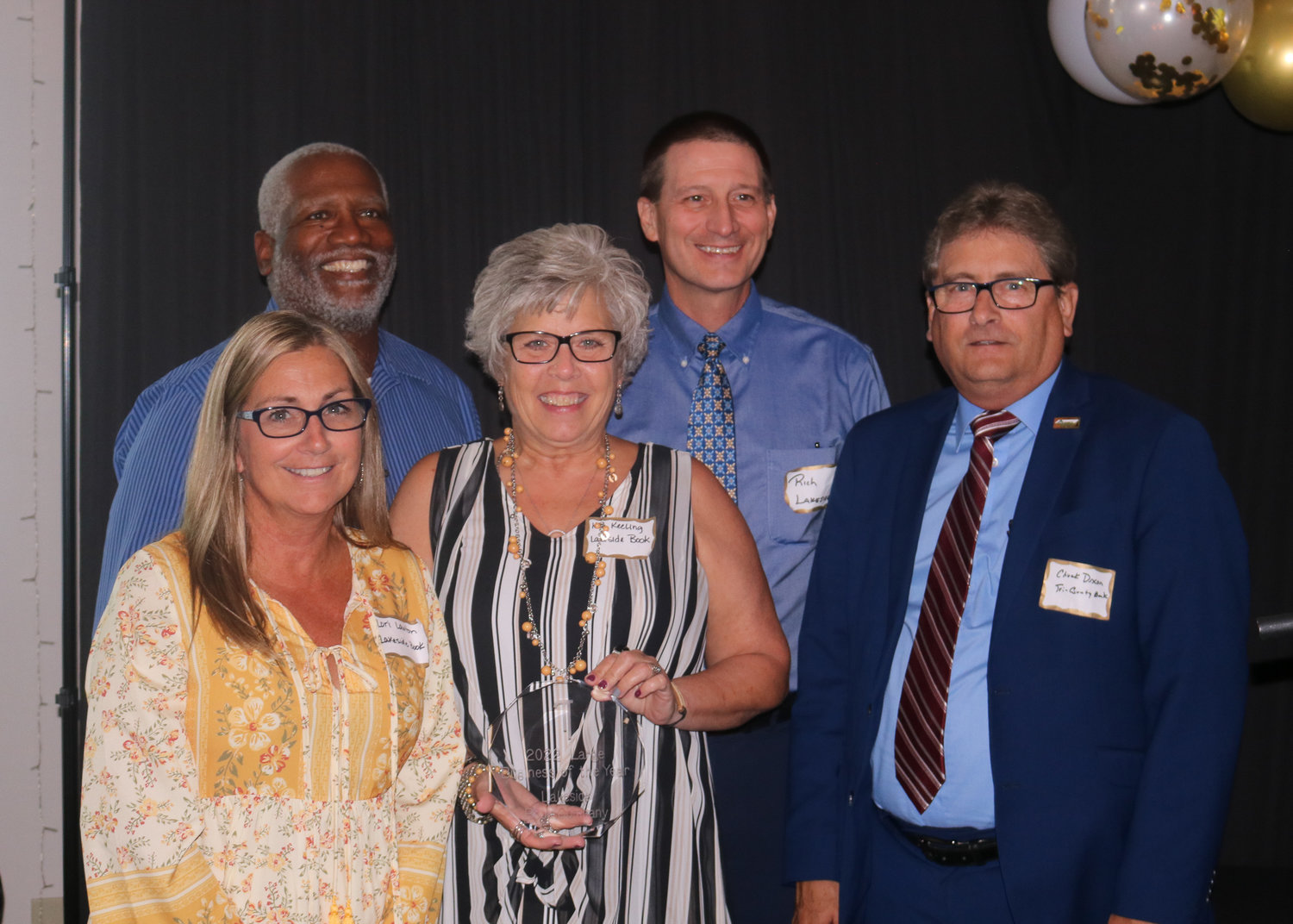 Tri-County Bank & Trust president and CEO Chuck Dixon, right, poses with members of the Lakeside Book Company team after accepting the Large Business of the Year award.