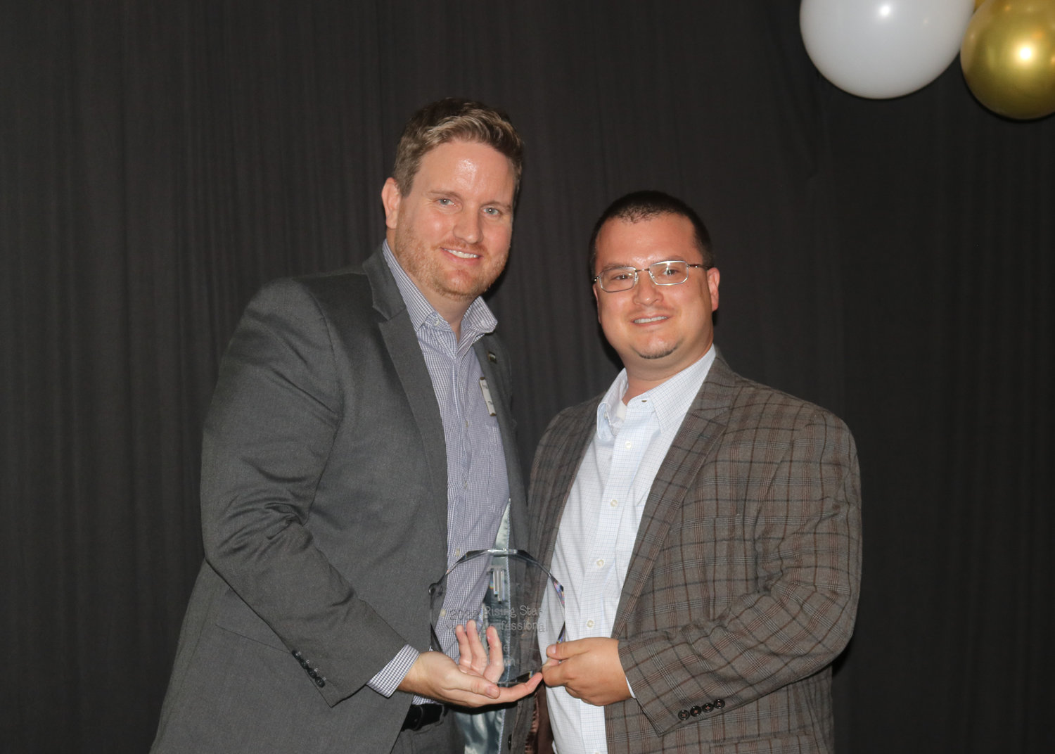 Kyle Brown, left, was named the Rising Star/Young Professional of the Year. He is pictured with Jim Johnson.