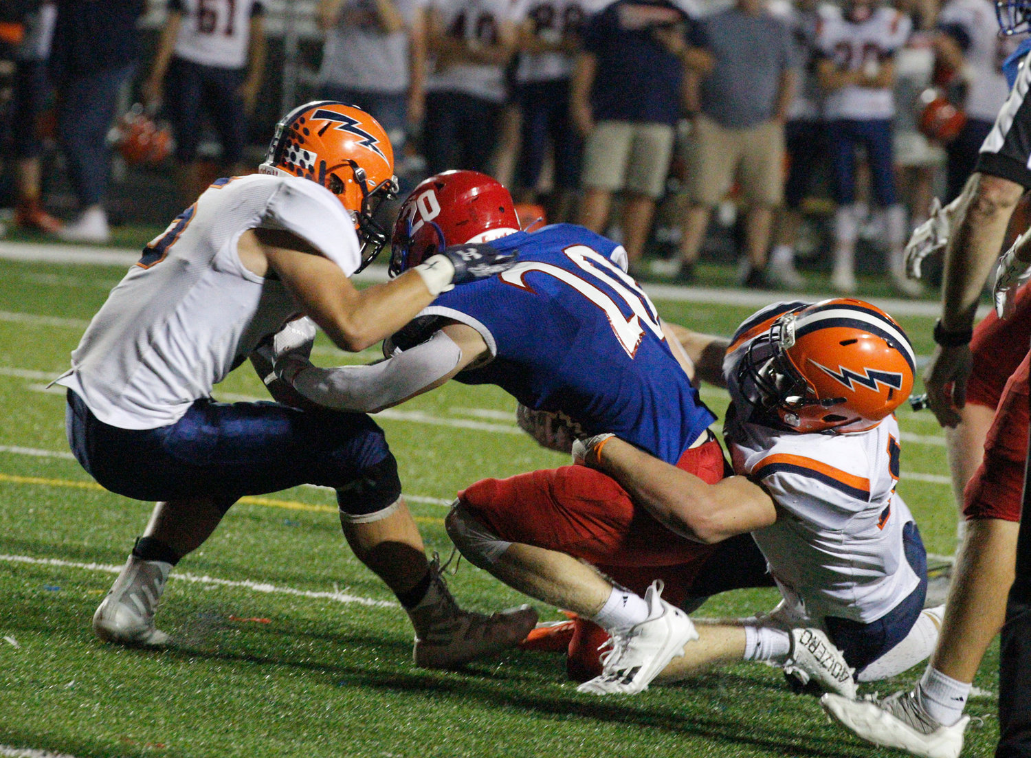 Thomas Laffoon and Austin Sulc combine for the tackle for the Chargers during their 35-8 loss to Western Boone.
