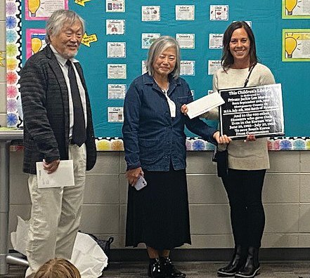 Pleasant Hill Elementary Principal Jennifer Moseley, right, accepts a plaque and funding from the 6.25 Foundation.