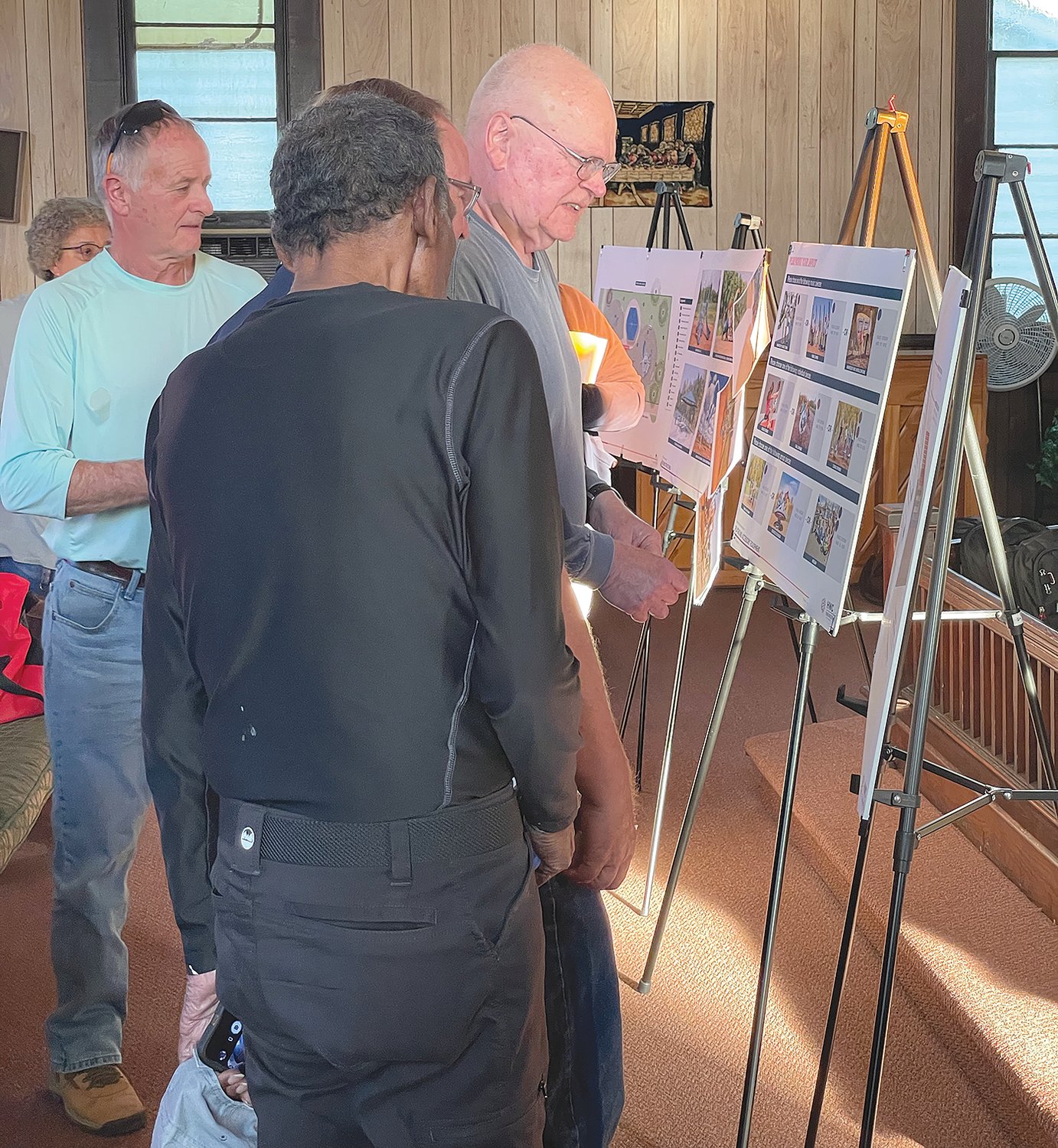 Mike Reidy, Crawfordsville City Councilman, center, reviews plans and playground equipment options Wednesday for the Frances Wooden Northside Park renovation project.