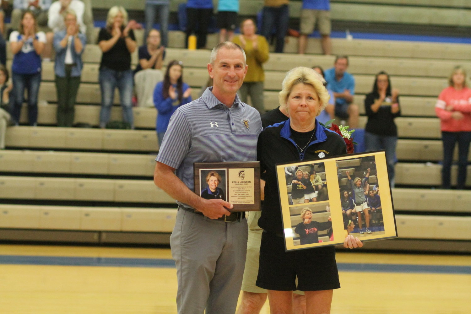 Crawfordsville AD Bryce Barton gives Johnson a ceremonial plaque and photo collage for during the pre-game ceremony for Johnson.
